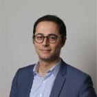 A person in a suit
Description automatically generated