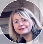 A person with blonde hair wearing glasses
Description automatically generated